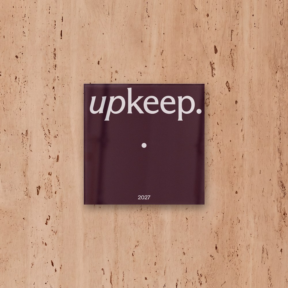 The Upkeep plaque with one Pearl, on a travertine studio wall