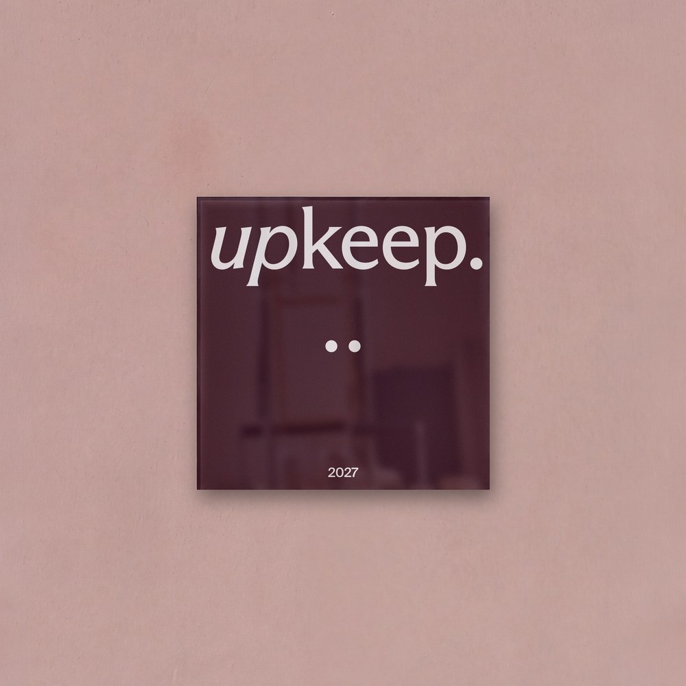 The Upkeep plaque with two Pearls, on a blush plaster studio wall