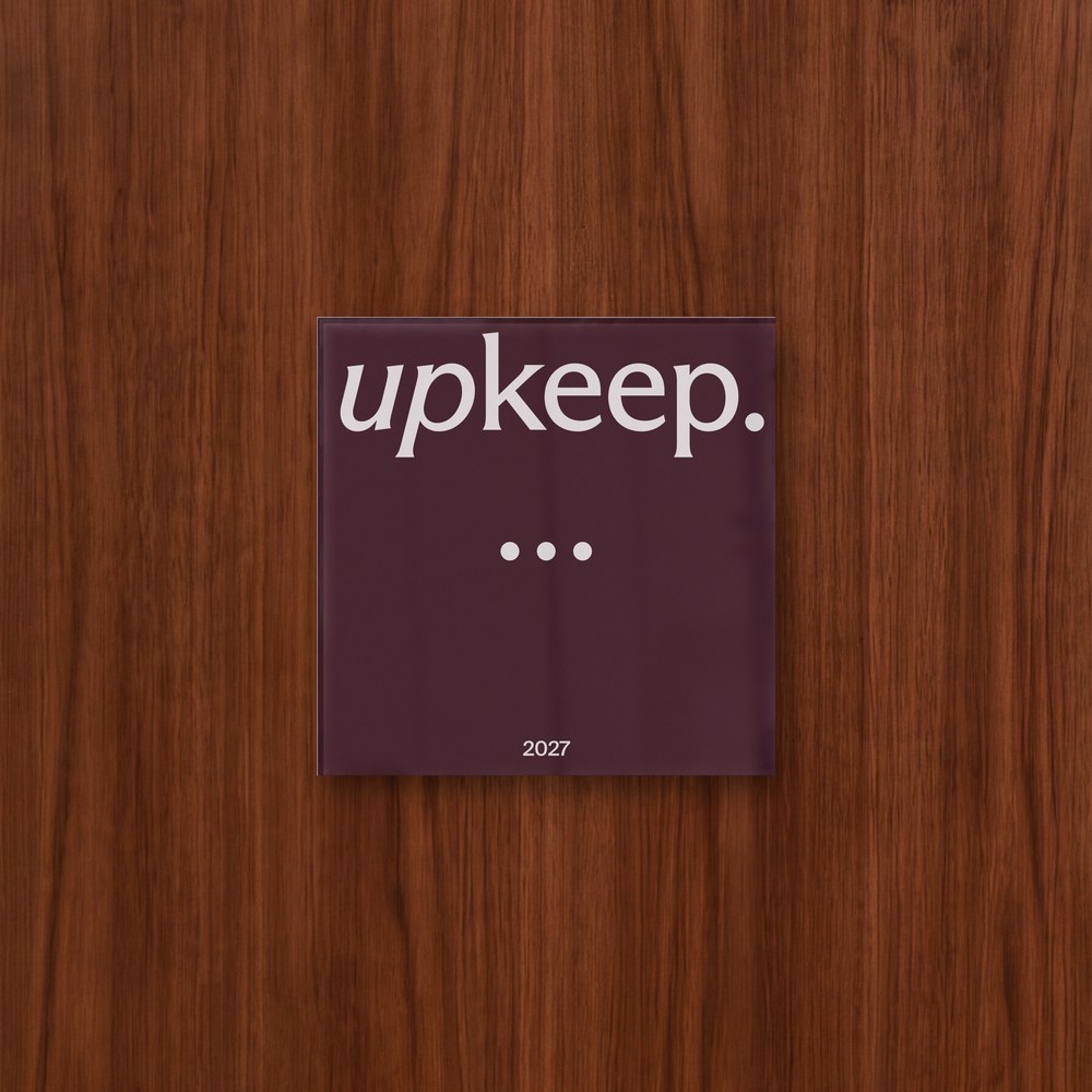 The Upkeep plaque with three Pearls, on a walnut-paneled studio wall